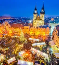Julemarked i Prag på den gamle rådhusplads med juletræ og Týn-kirken – togrejse til julemarked i Europa