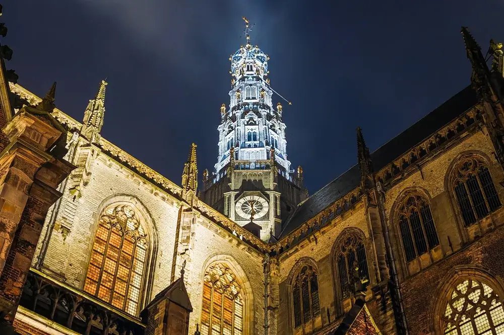 Det oplyste tårn på Grote Kerk (Sint-Bavokerk) i Haarlem om aftenen