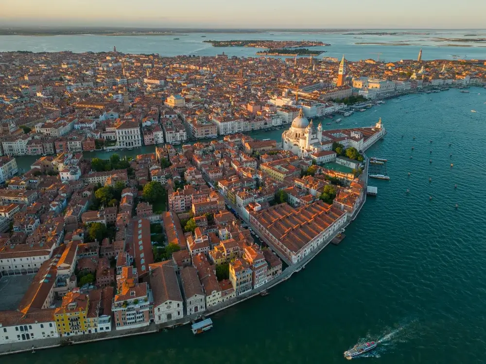 Luftfoto af Venedig ved solnedgang med Santa Maria della Salute og lagunen