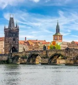 Karlsbroen med det gotiske brotårn set fra Vltava-floden i Prag en sommerdag